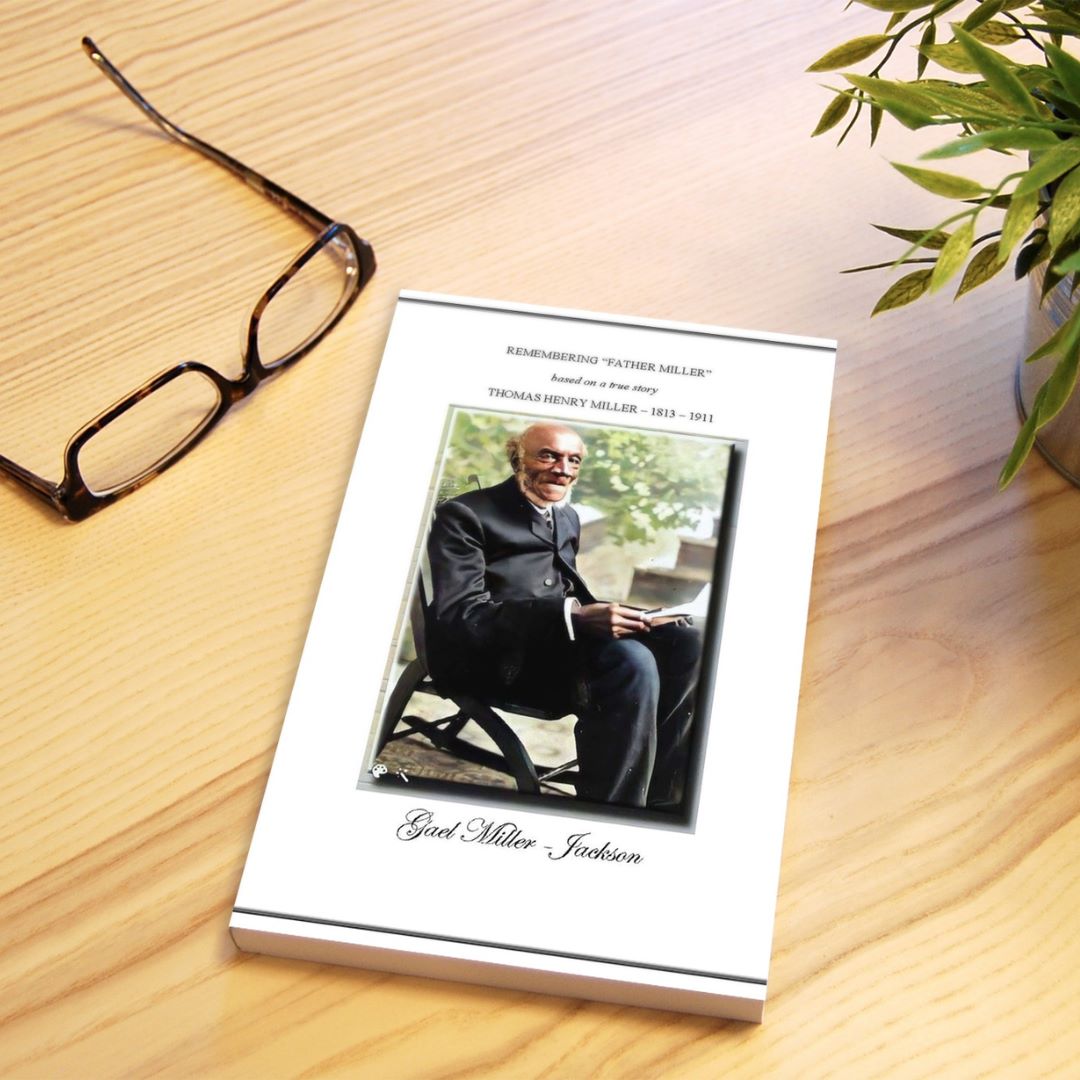 book on table with glasses and plant in background